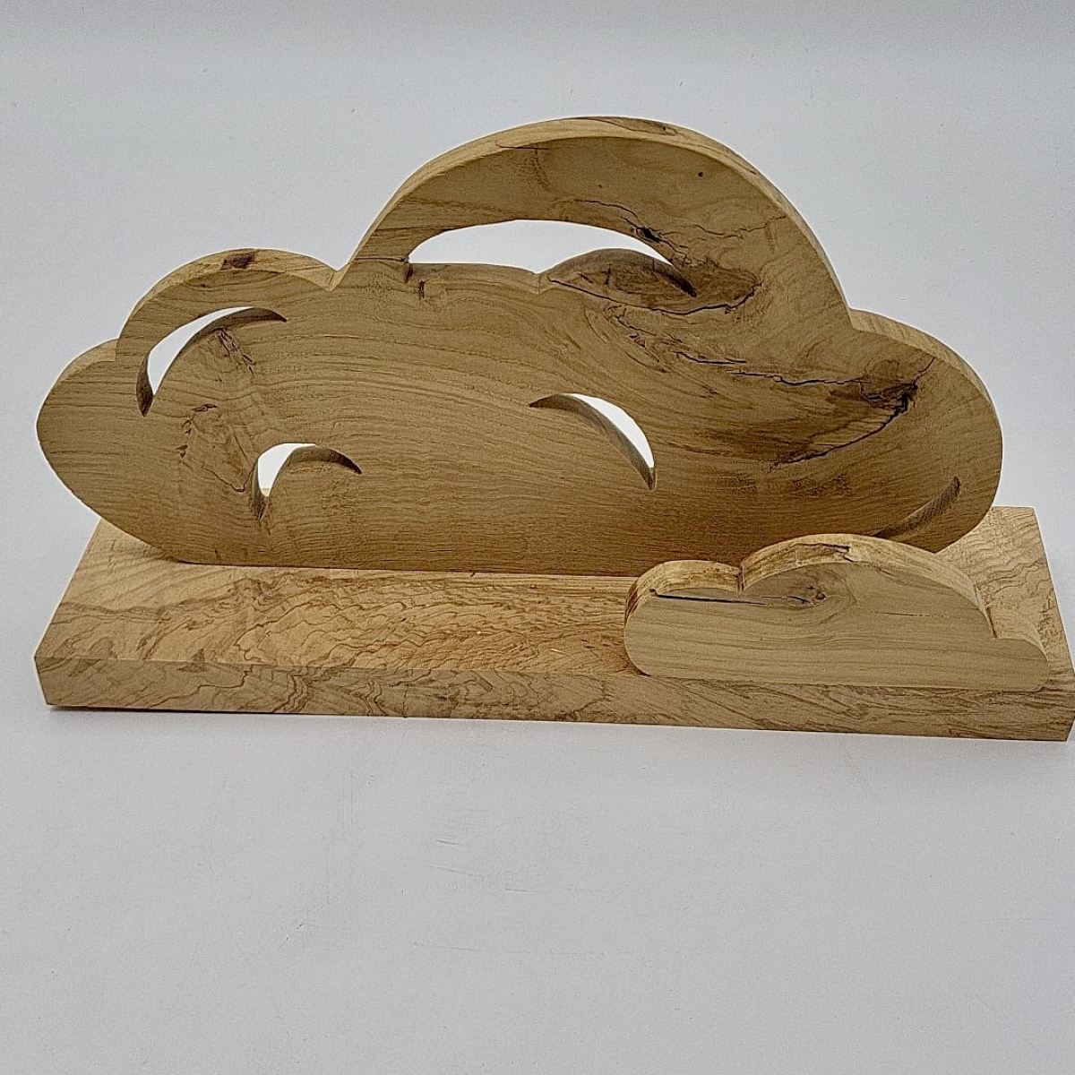 wooden sculpture of two clouds